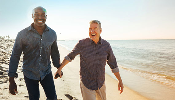 Two men walking along a beach