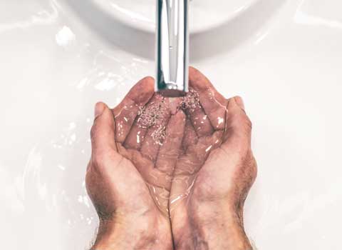 Man washing his hands in sink