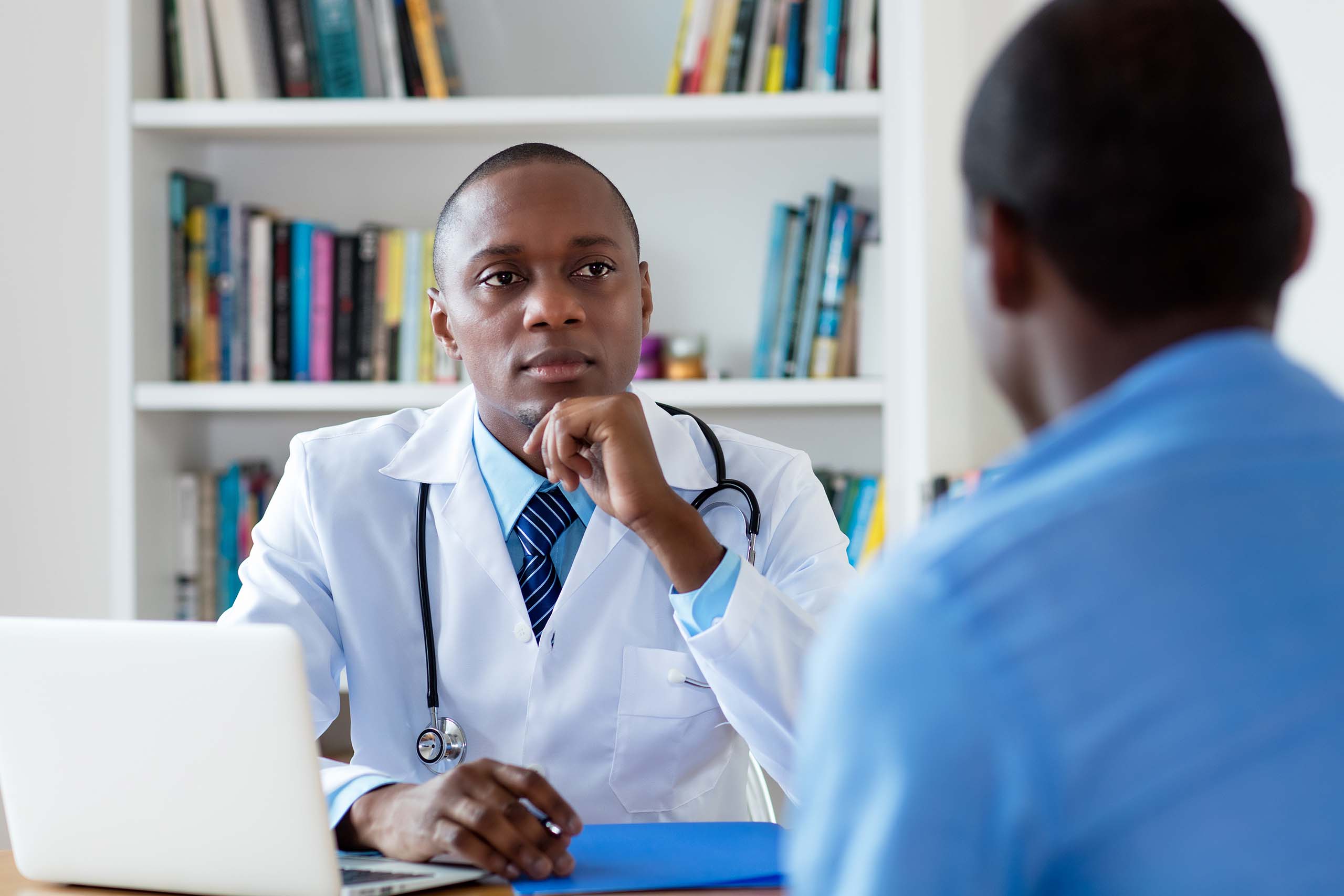 Man talking to gay friendly doctor