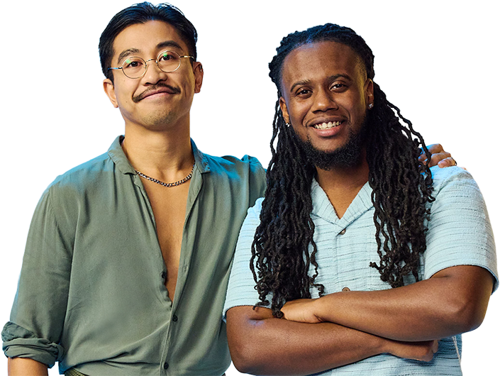 An Asian male and black male against a vibrant blue and yellow gradient backdrop. One embraces the other, both projecting a calm, relaxed and happy vibe.