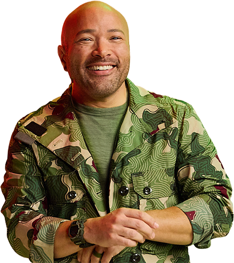 Smiling man in a camo jacket stands against a vibrant red and green gradient background. He exudes a cheerful and confident vibe.