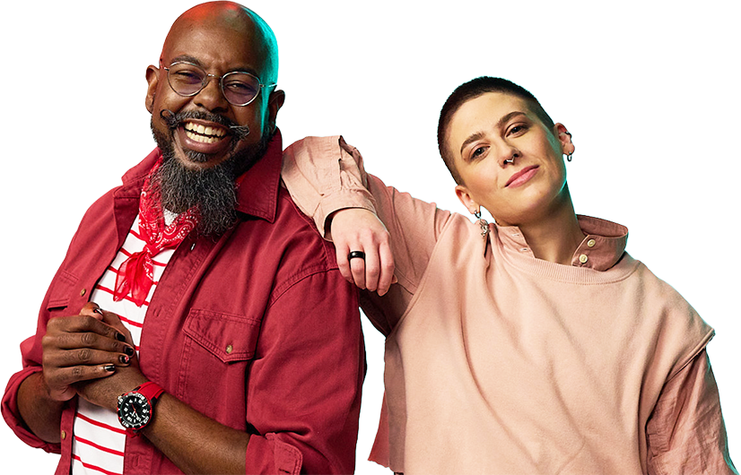 A large joyful man in a red shirt and glasses stands with a smiling person in a pink top. They share a friendly, relaxed pose against a vibrant background.