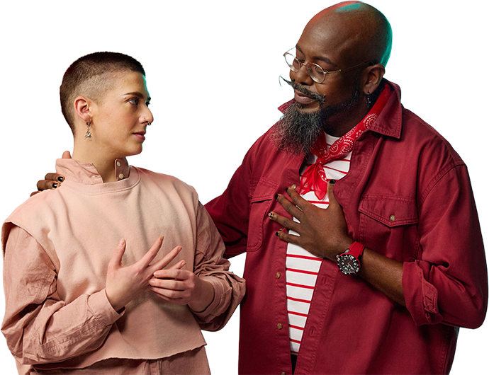 Two people stand against a black background, engaging in a heartfelt conversation. The person on the left, in pink, and the person on the right, in red, share a sincere moment.